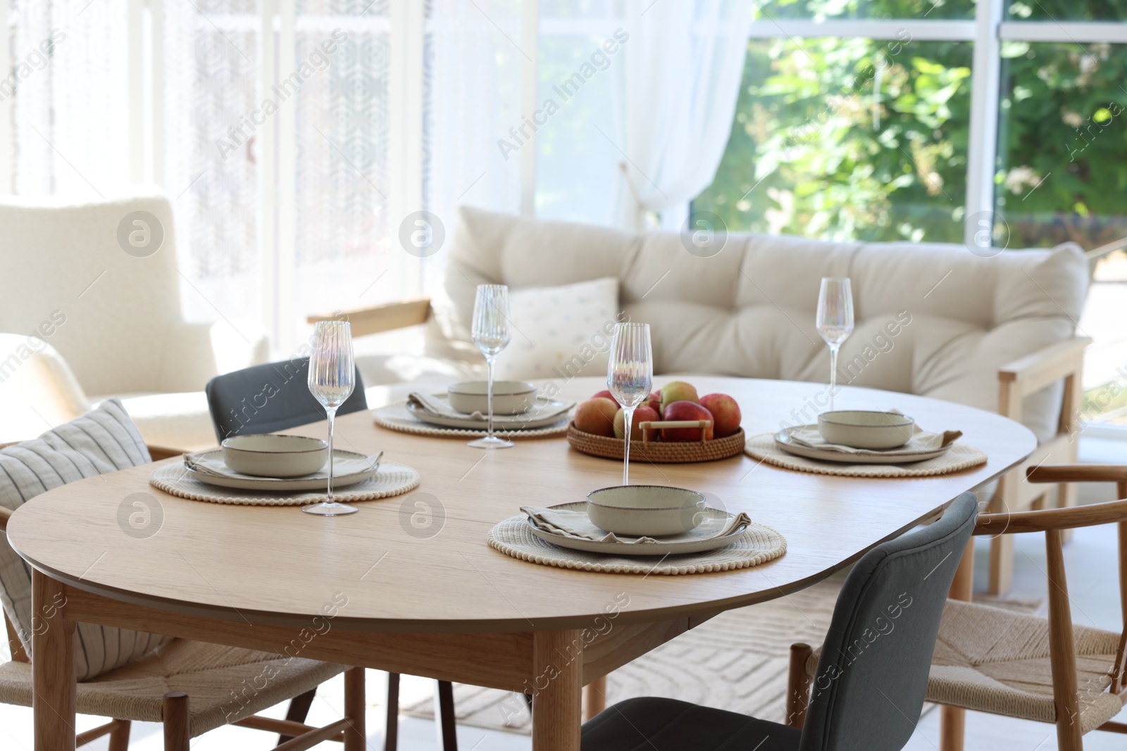 Beautiful table setting, chairs and decor in dining room. Interior design Photo of Beautiful table setting, chairs and decor in dining room. Interior design