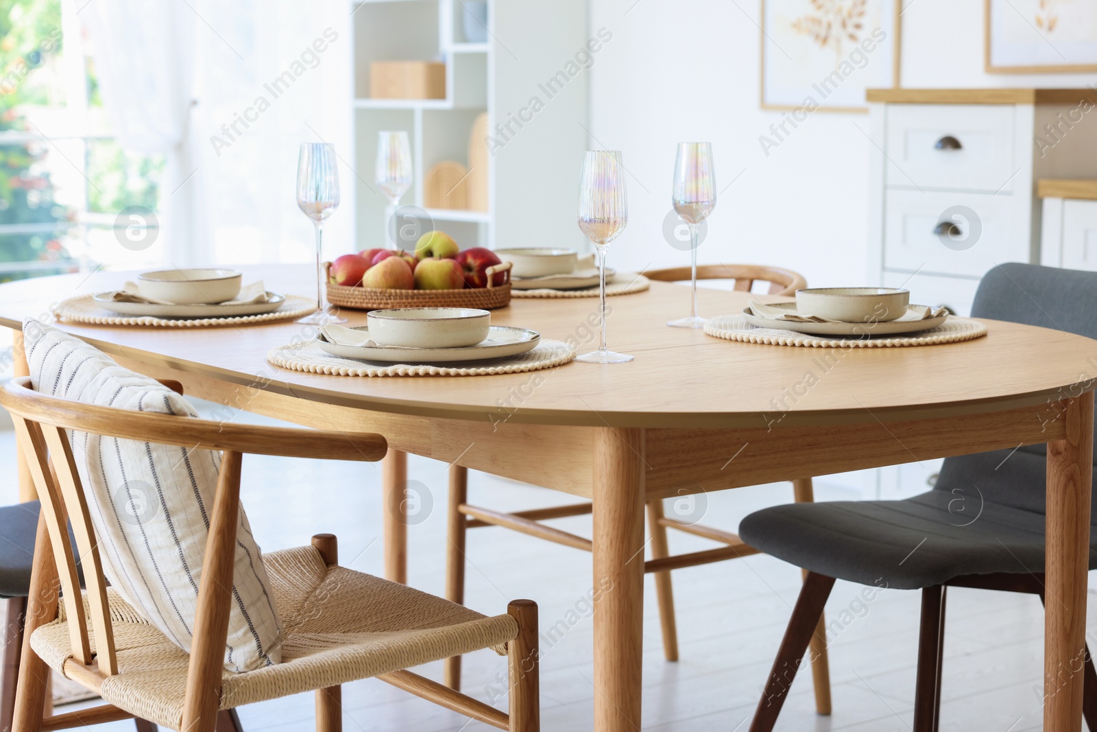 Beautiful table setting, chairs and decor in dining room. Interior design Photo of Beautiful table setting, chairs and decor in dining room. Interior design