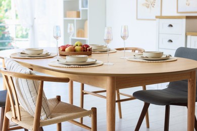 Photo of Beautiful table setting, chairs and decor in dining room. Interior design