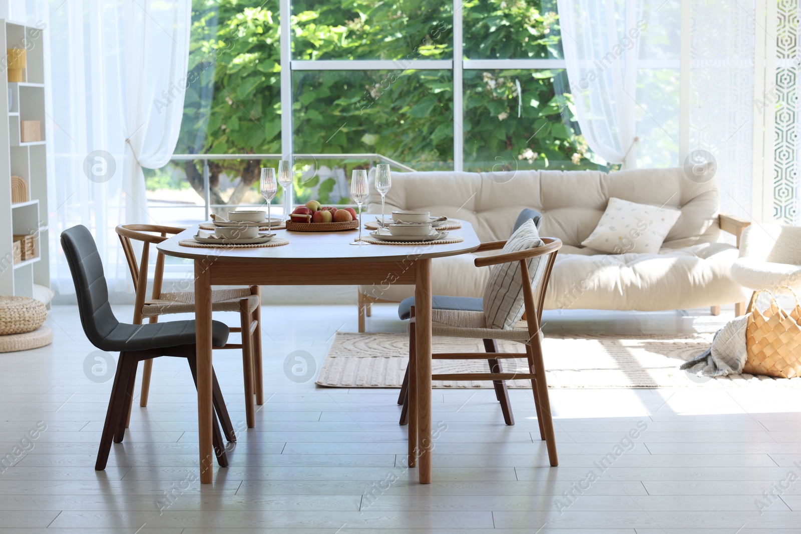 Beautiful table setting, chairs and decor in dining room. Interior design Photo of Beautiful table setting, chairs and decor in dining room. Interior design