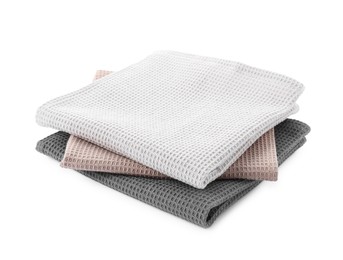 Photo of Clean colorful waffle towels isolated on white
