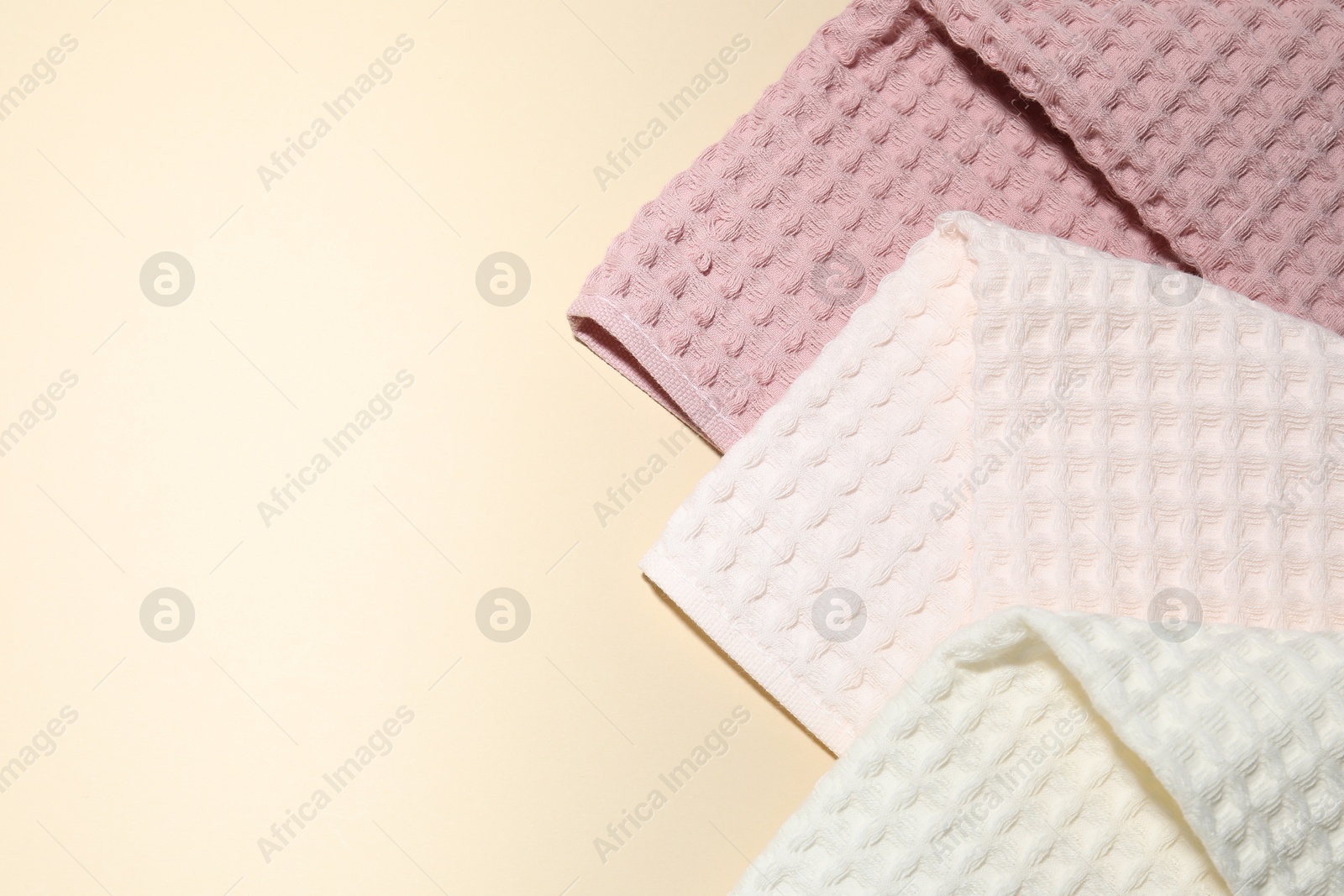 Photo of Clean waffle towels on beige background, top view. Space for text