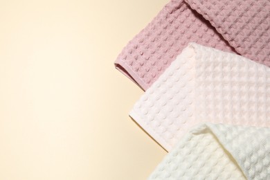 Photo of Clean waffle towels on beige background, top view. Space for text