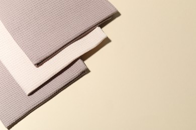 Photo of Clean waffle towels on beige background, top view. Space for text