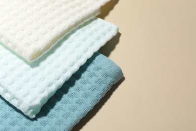 Photo of Clean waffle towels on beige background, above view. Space for text
