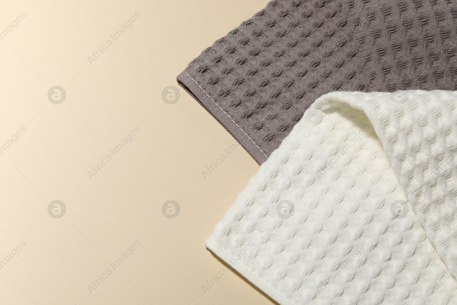 Photo of Clean waffle towels on beige background, top view. Space for text
