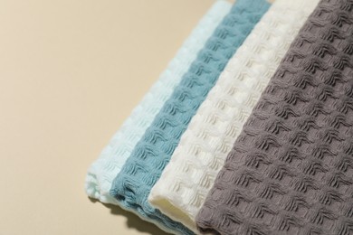 Photo of Clean waffle towels on beige background, closeup. Space for text