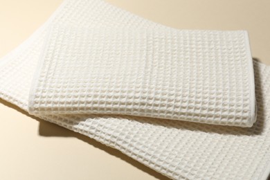 Photo of Clean waffle towels on beige background, closeup
