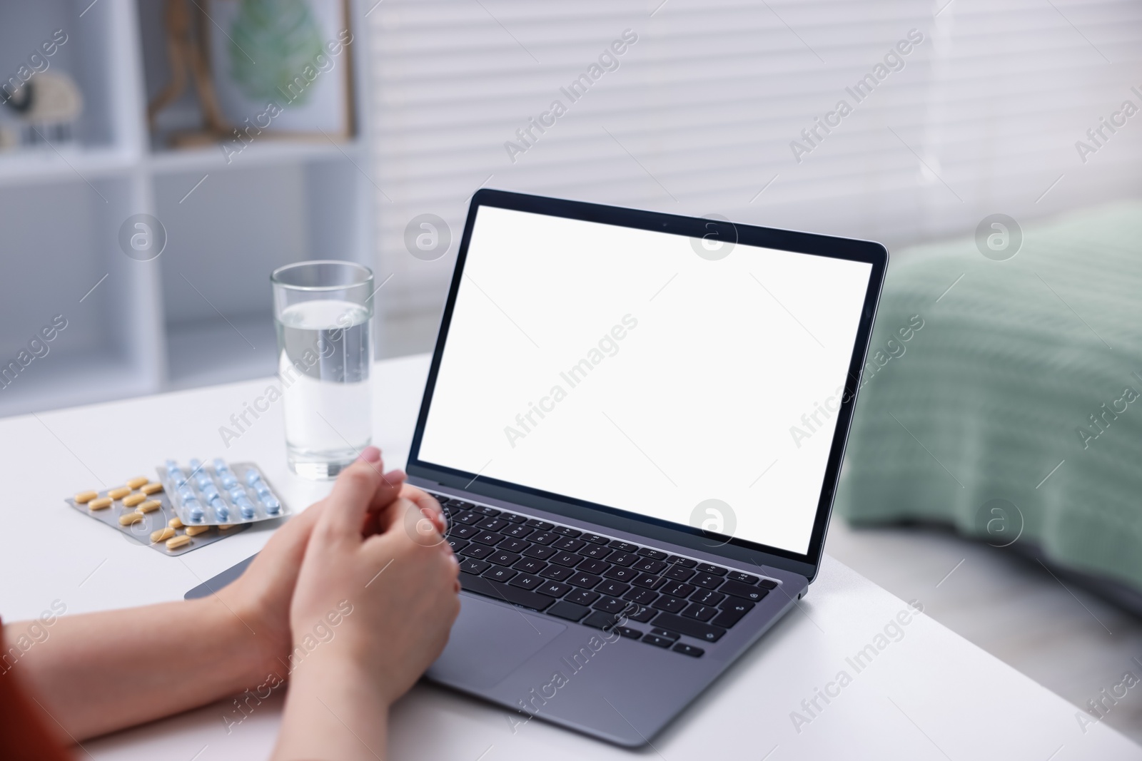 Woman having online consultation with doctor via laptop at table indoors, closeup Photo of Woman having online consultation with doctor via laptop at table indoors, closeup