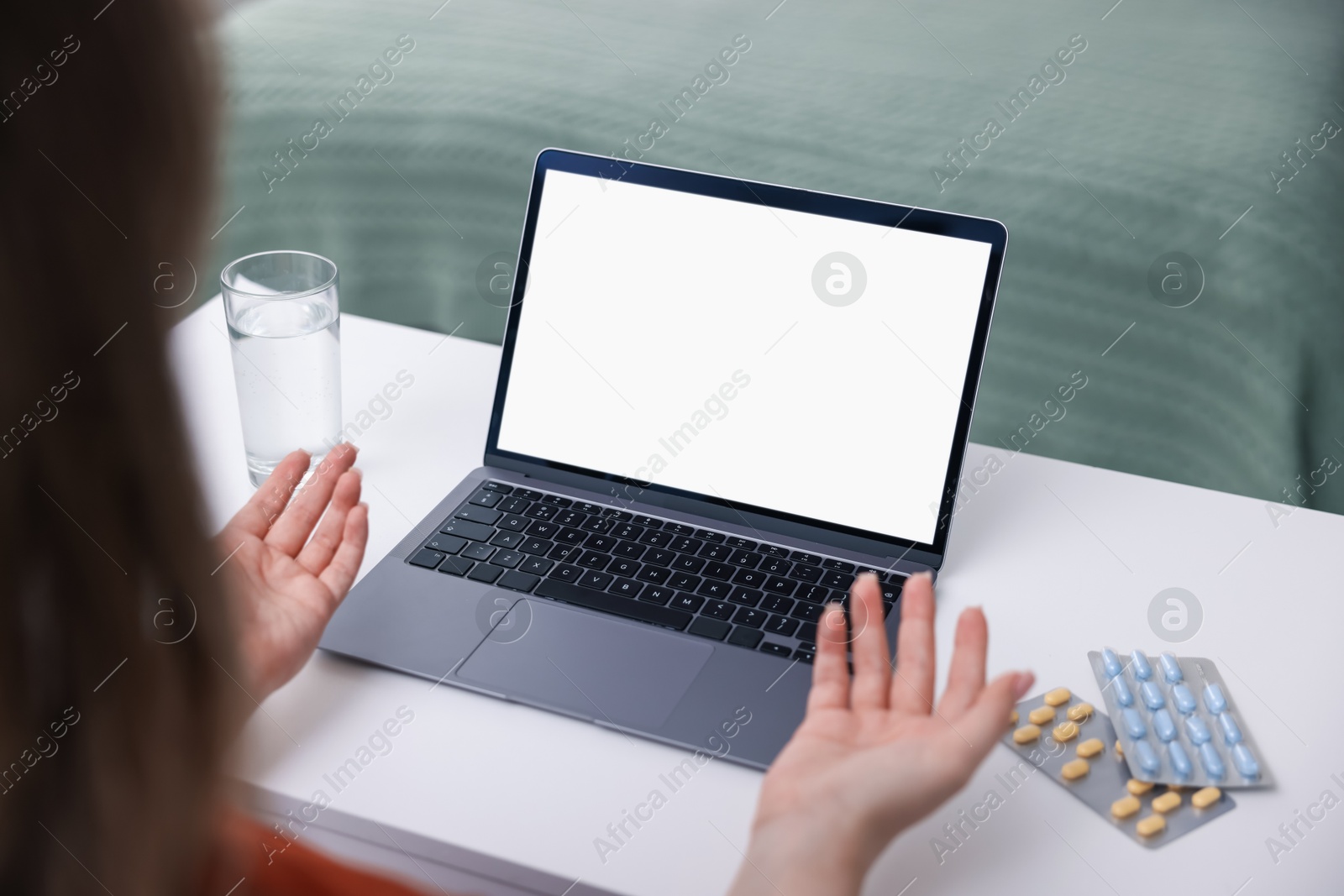 Woman having online consultation with doctor via laptop at table indoors, closeup Photo of Woman having online consultation with doctor via laptop at table indoors, closeup