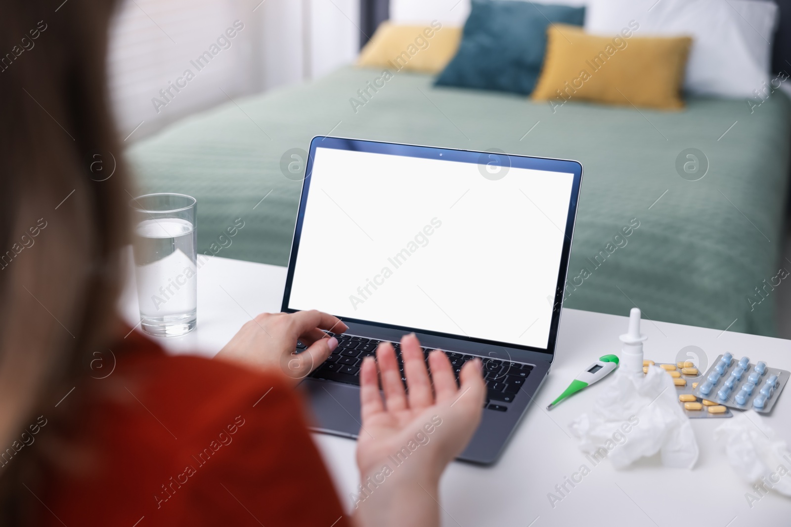Woman having online consultation with doctor via laptop at table indoors, closeup Photo of Woman having online consultation with doctor via laptop at table indoors, closeup