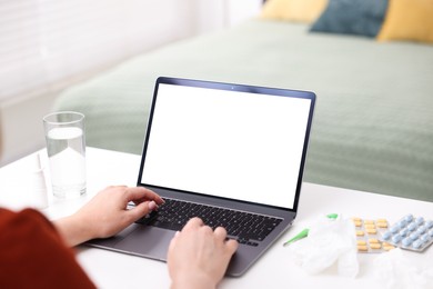 Photo of Woman having online consultation with doctor via laptop at table indoors, closeup