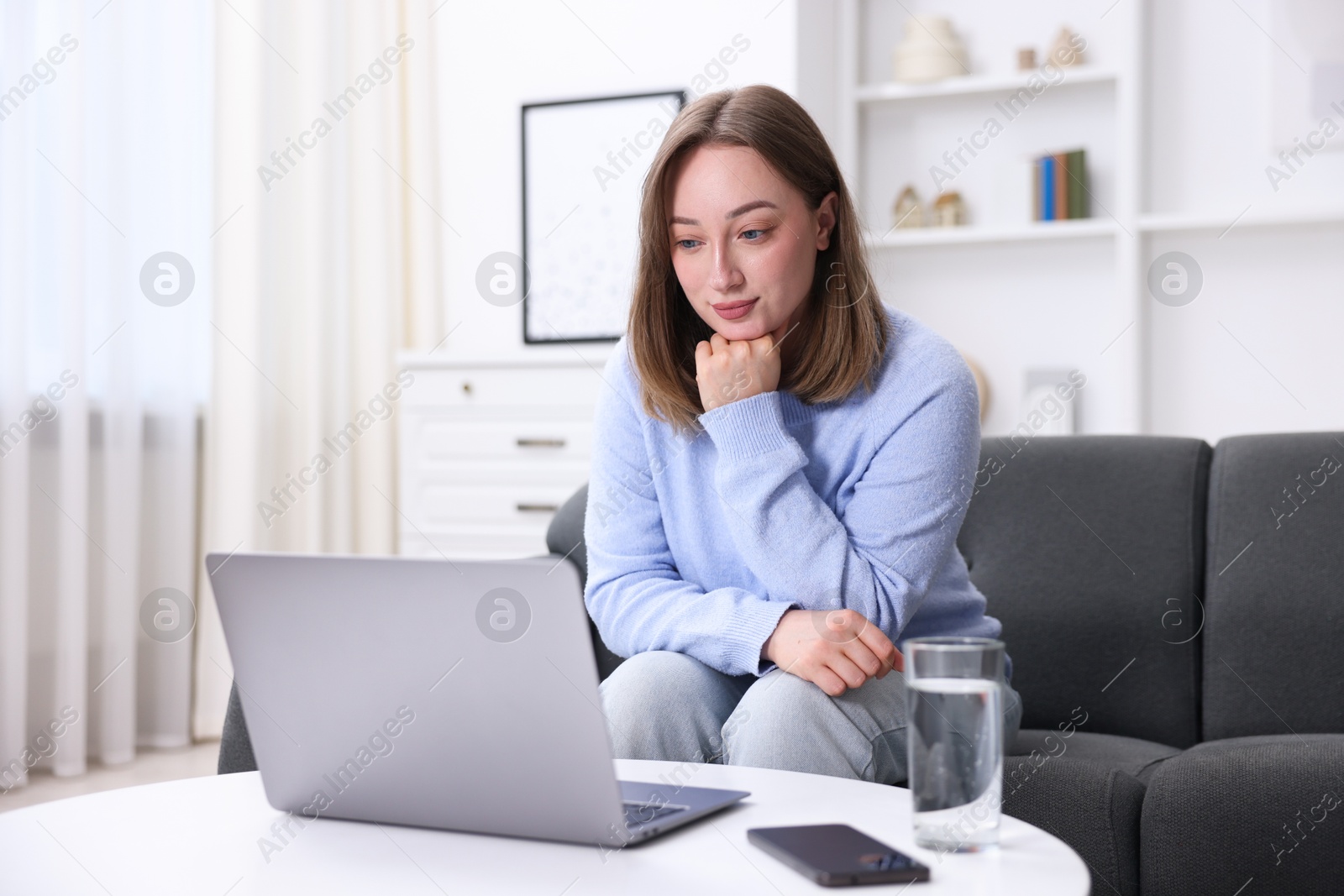 Woman having online consultation with doctor via laptop at home Photo of Woman having online consultation with doctor via laptop at home