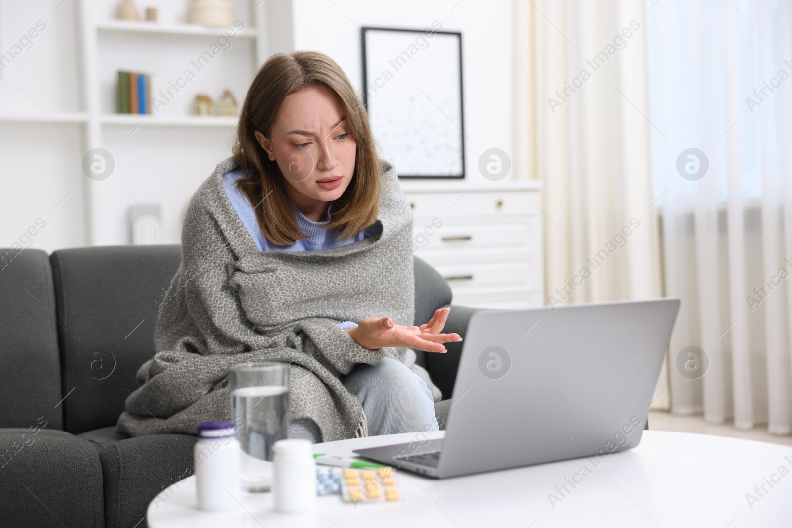 Sick woman having online consultation with doctor via laptop at home Photo of Sick woman having online consultation with doctor via laptop at home