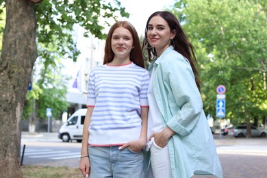 Photo of Beautiful mother and her teenage daughter on city street