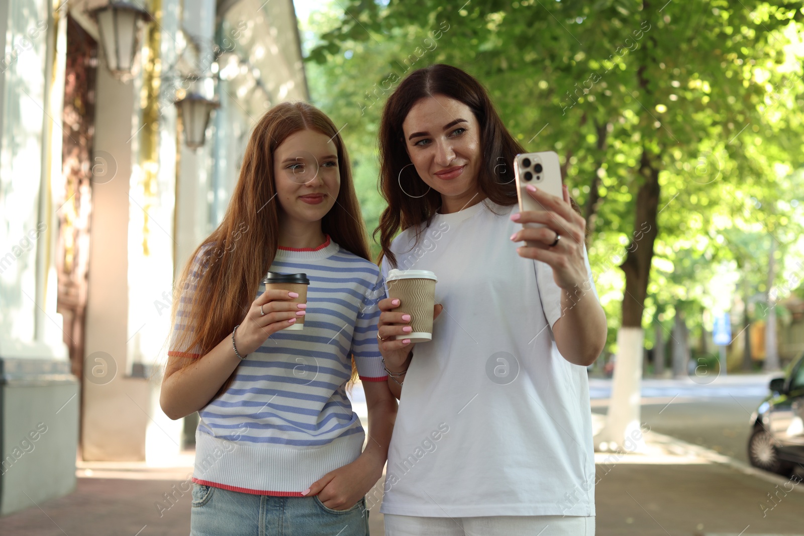 Mother and her teenage daughter taking selfie outdoors Photo of Mother and her teenage daughter taking selfie outdoors