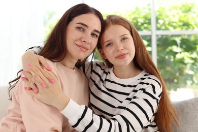 Photo of Portrait of mother and her teenage daughter at home