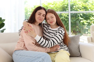 Photo of Mother and her teenage daughter spending time together at home
