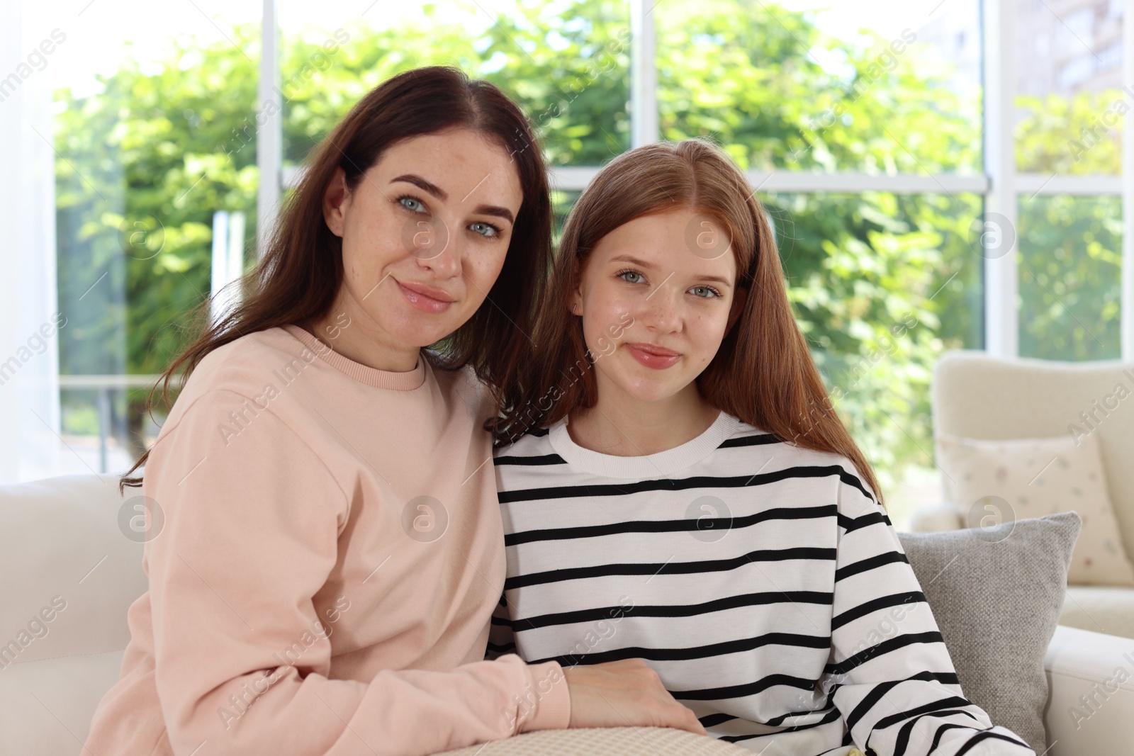 Photo of Portrait of mother and her teenage daughter at home