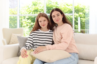 Photo of Portrait of mother and her teenage daughter at home