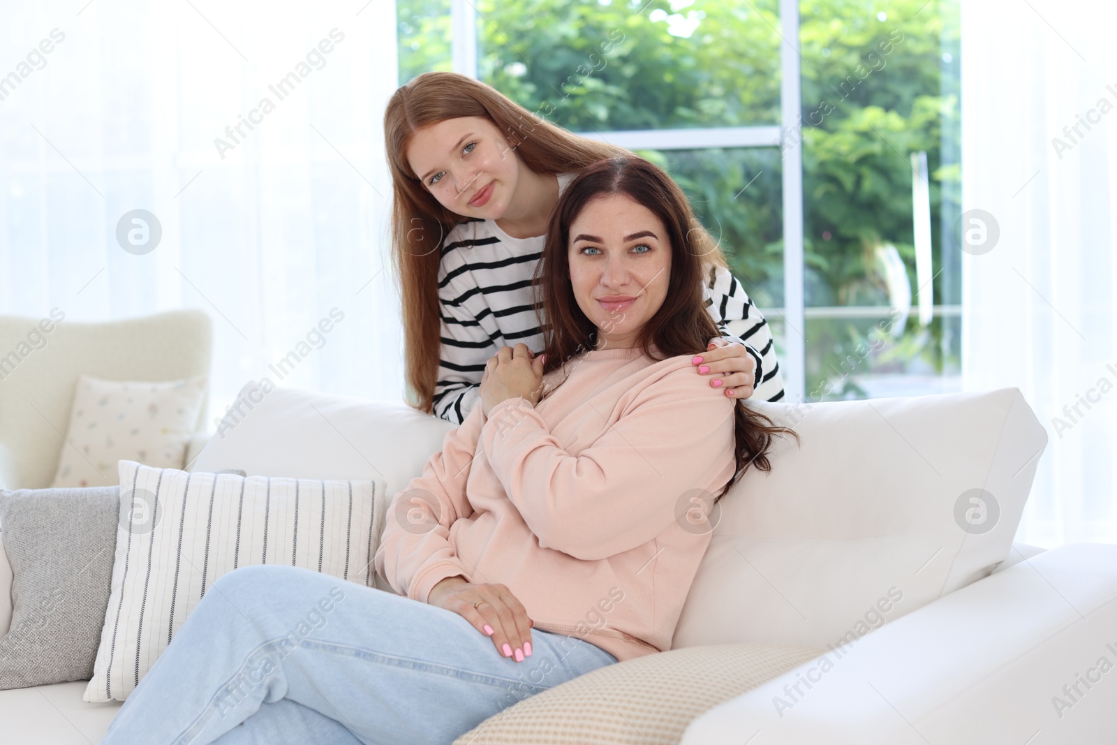 Photo of Portrait of mother and her teenage daughter at home