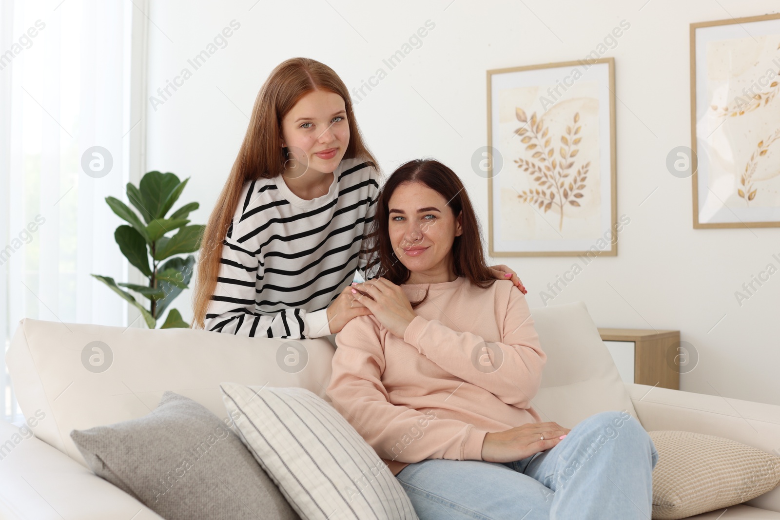 Photo of Portrait of mother and her teenage daughter at home