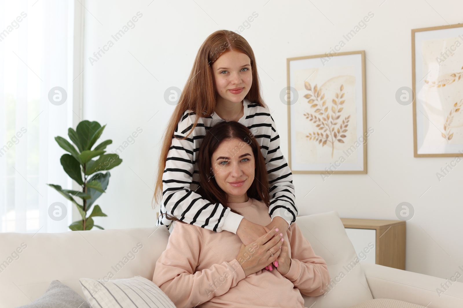 Photo of Portrait of mother and her teenage daughter at home