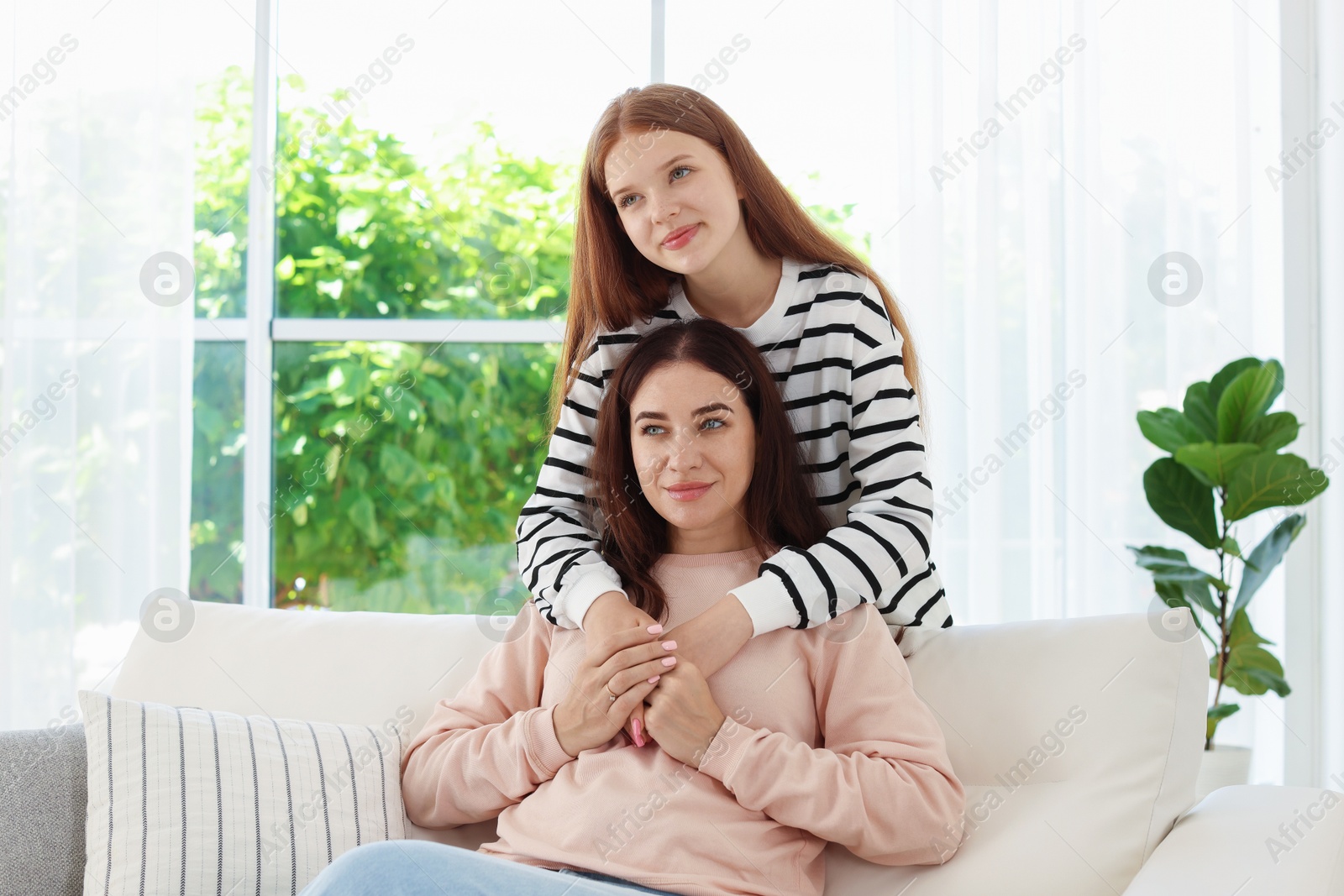 Photo of Portrait of mother and her teenage daughter at home