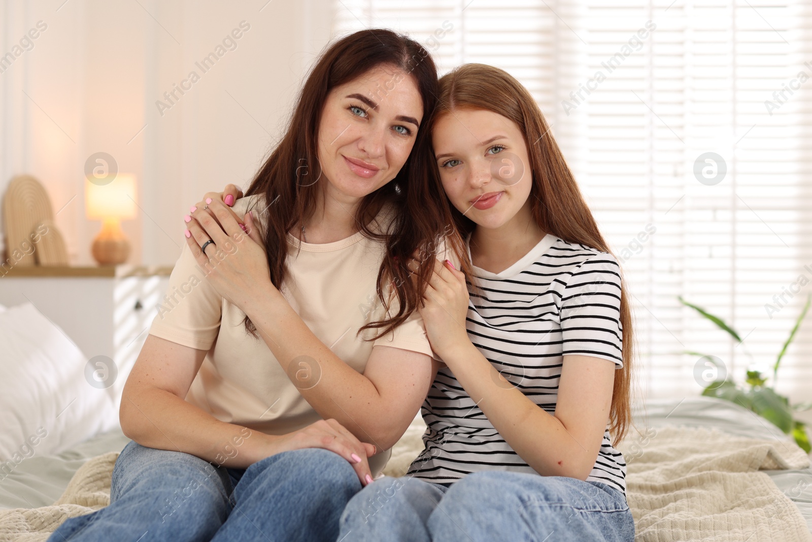Photo of Portrait of mother and her teenage daughter at home