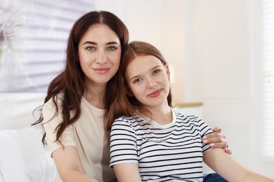 Photo of Portrait of mother and her teenage daughter at home