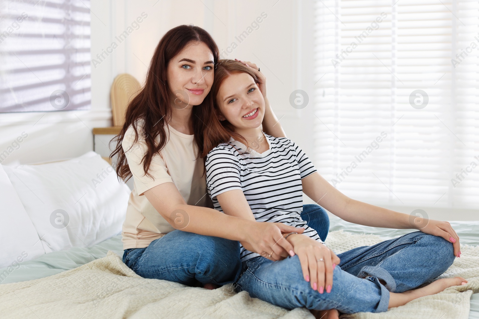 Photo of Portrait of mother and her teenage daughter at home