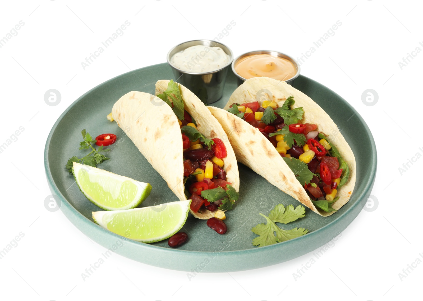 Photo of Tasty vegetarian tacos with beans, vegetables, sauces and lime isolated on white