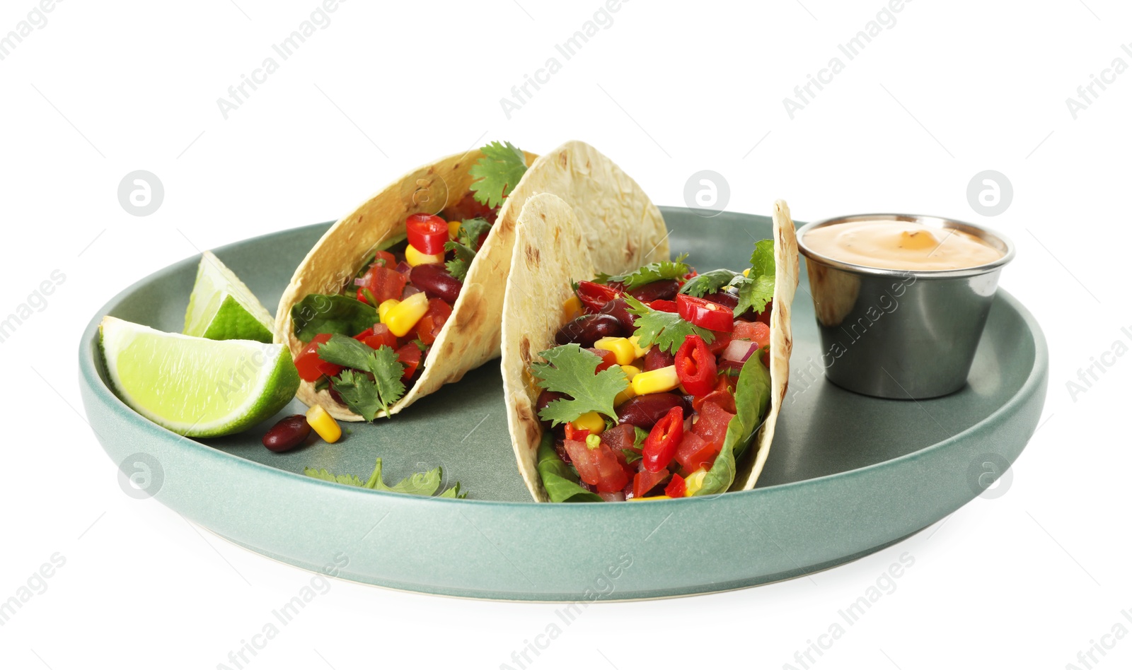Photo of Tasty vegetarian tacos with beans, vegetables, sauce and lime isolated on white