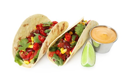Photo of Tasty vegetarian tacos with beans, vegetables, sauce and lime isolated on white