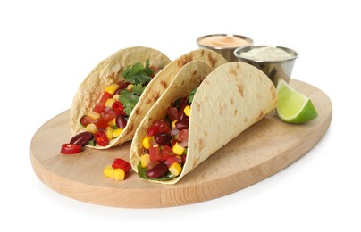 Photo of Tasty vegetarian tacos with beans, vegetables, sauces and lime isolated on white