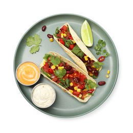 Photo of Tasty vegetarian tacos with beans, vegetables, sauces and lime isolated on white, top view