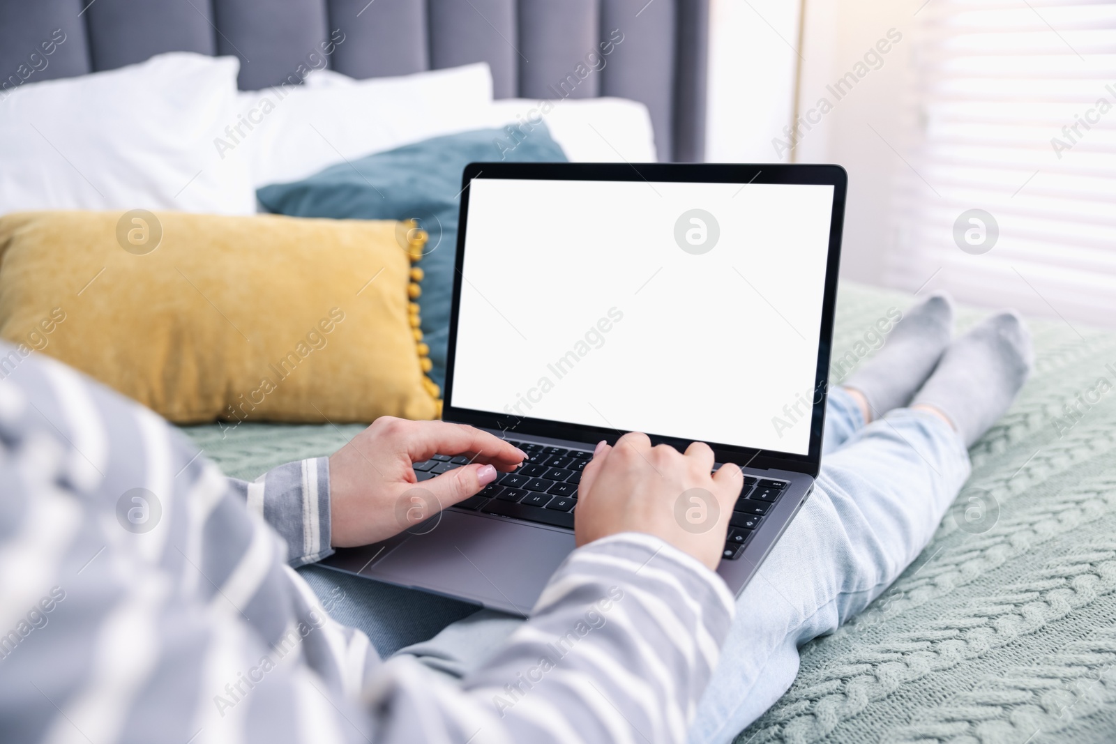 Woman having online consultation with doctor via laptop on bed at home, closeup Photo of Woman having online consultation with doctor via laptop on bed at home, closeup
