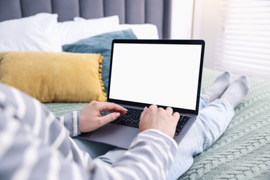 Photo of Woman having online consultation with doctor via laptop on bed at home, closeup