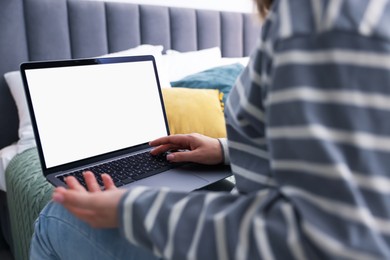 Photo of Woman having online consultation with doctor via laptop on bed at home, closeup