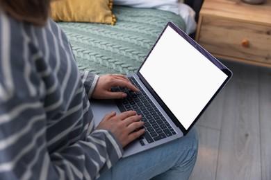 Photo of Woman having online consultation with doctor via laptop on bed at home, closeup