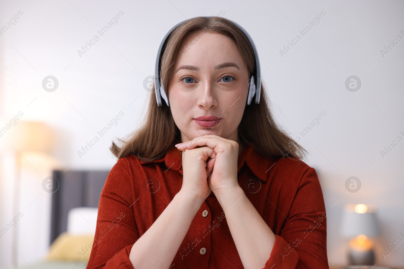Woman in headphones having online consultation with doctor at home Photo of Woman in headphones having online consultation with doctor at home