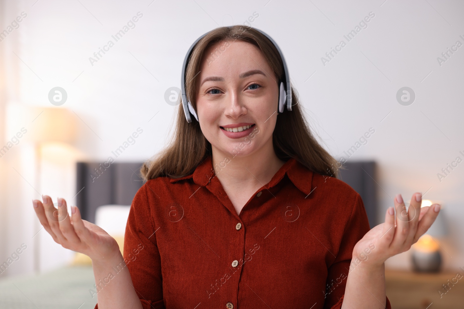 Woman in headphones having online consultation with doctor at home Photo of Woman in headphones having online consultation with doctor at home