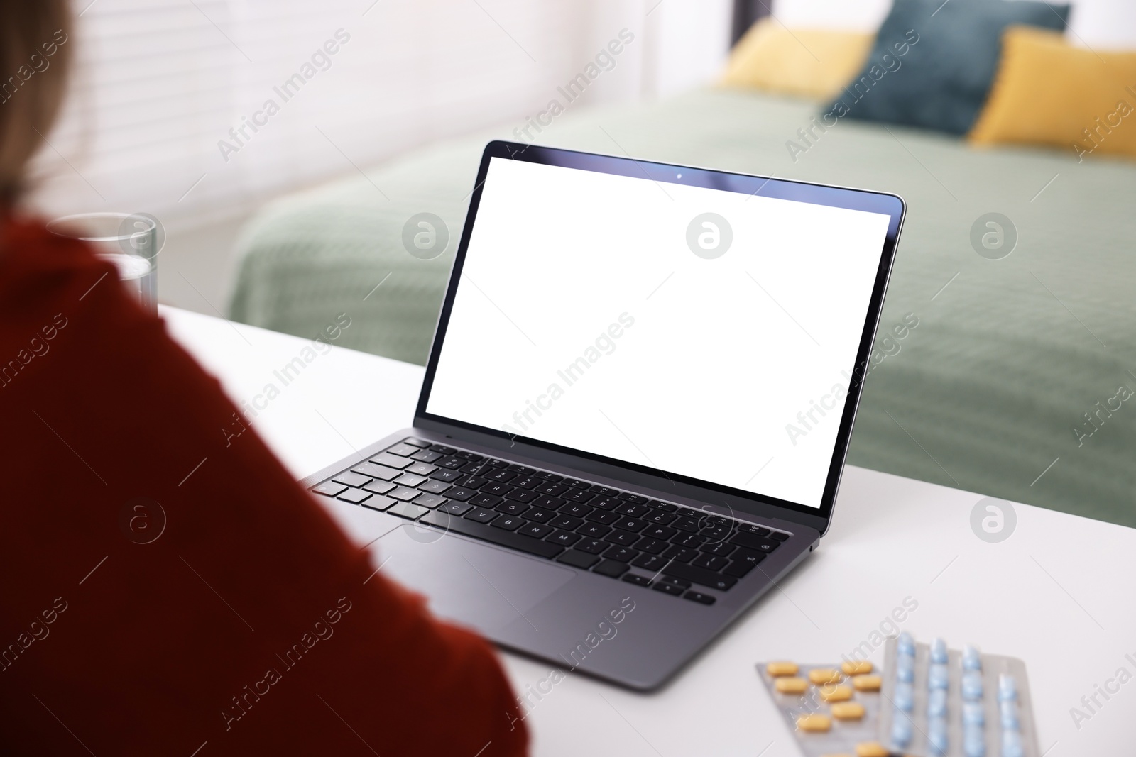Woman having online consultation with doctor via laptop at table indoors, closeup Photo of Woman having online consultation with doctor via laptop at table indoors, closeup