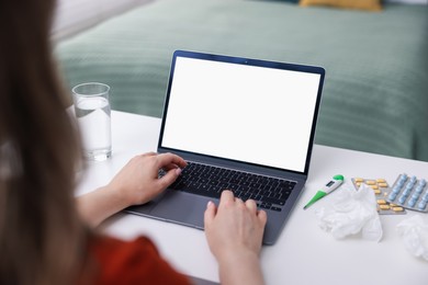 Photo of Woman having online consultation with doctor via laptop at table indoors, closeup