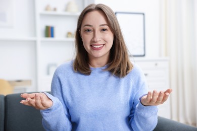 Photo of Portrait of happy woman at home. Online medical consultation