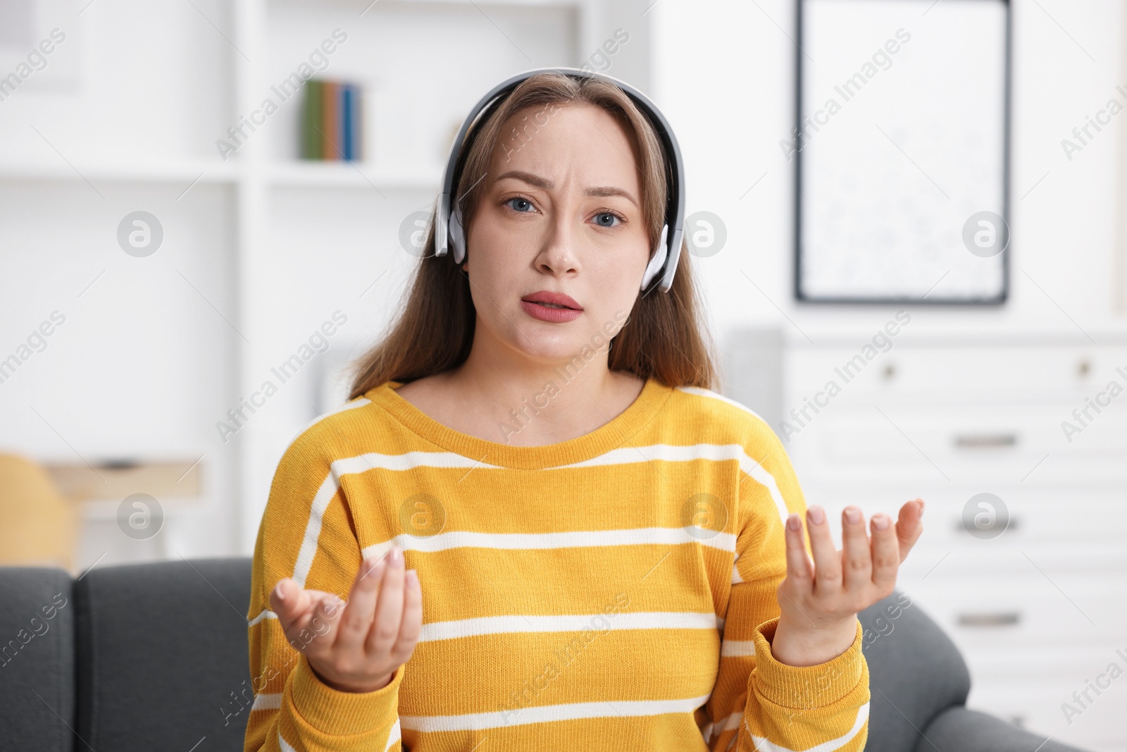 Woman in headphones having online consultation with doctor at home Photo of Woman in headphones having online consultation with doctor at home