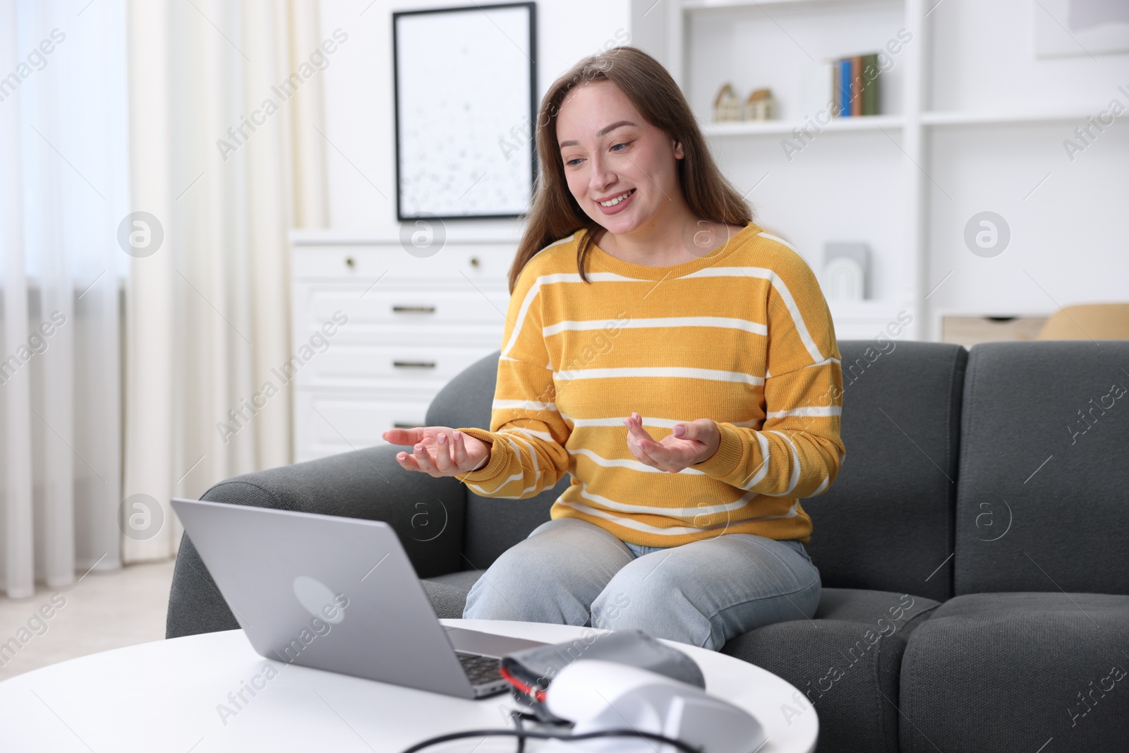 Woman having online consultation with doctor via laptop at home Photo of Woman having online consultation with doctor via laptop at home