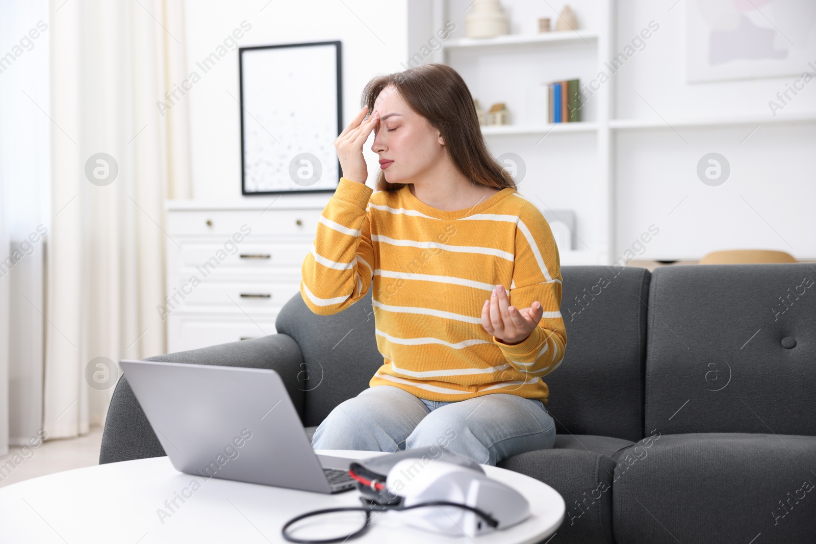 Sick woman having online consultation with doctor via laptop at home Photo of Sick woman having online consultation with doctor via laptop at home