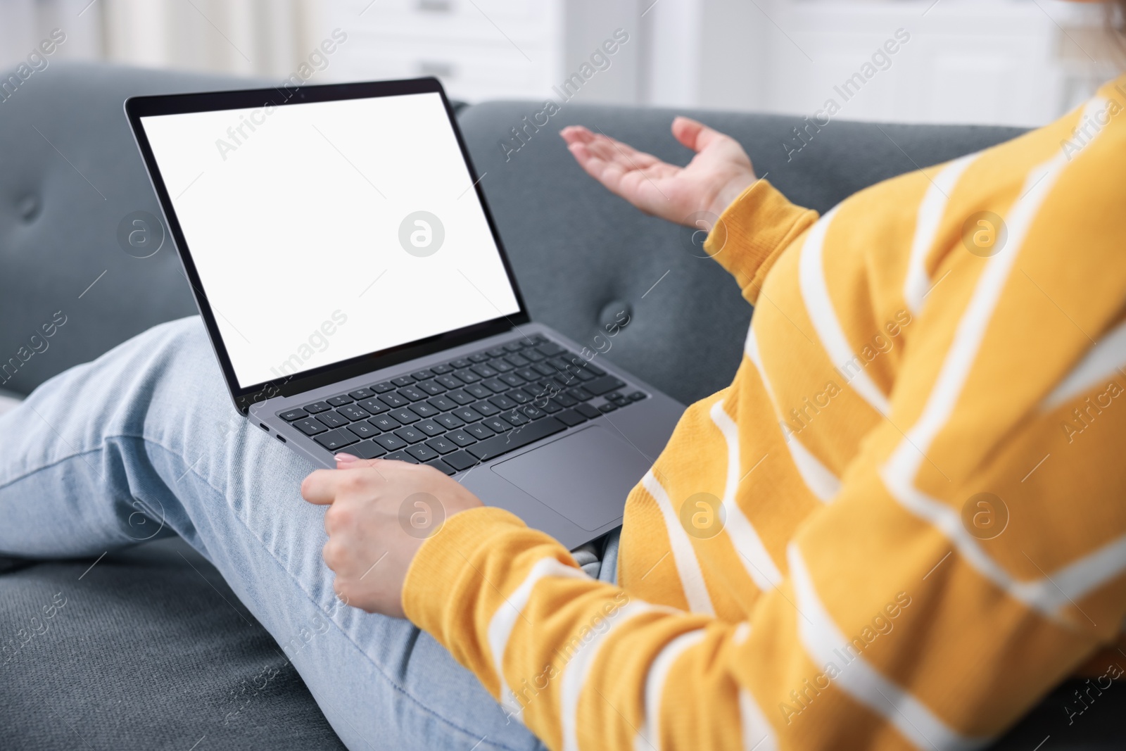 Photo of Woman having online consultation with doctor via laptop on sofa at home, closeup