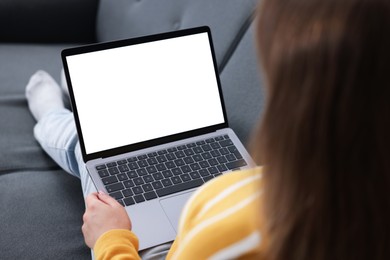 Photo of Woman having online consultation with doctor via laptop on sofa at home, closeup